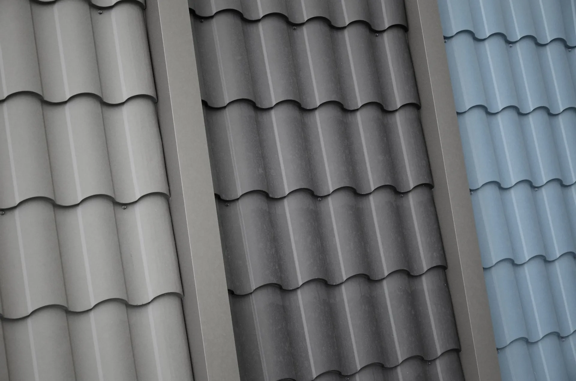 The image displays three vertical sections of roof tiles, each with a different grayscale filter, showing a contrast between shades from light to dark.