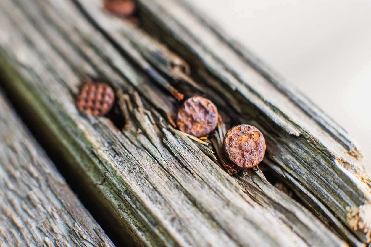 Rusty nail in wood beam